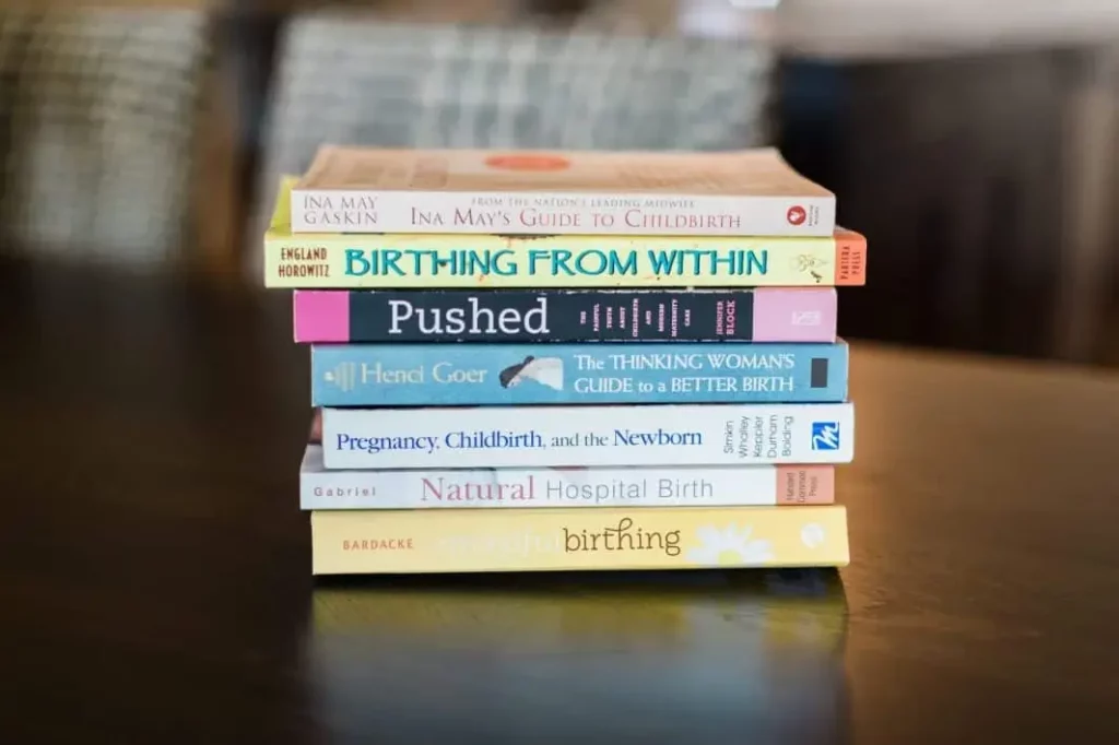 A stack of birthing books on the table