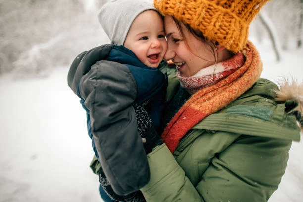 baby and mother in the snow