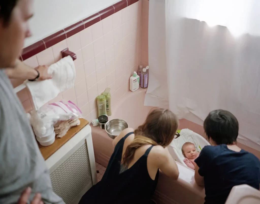 postpartum doula helping with bath