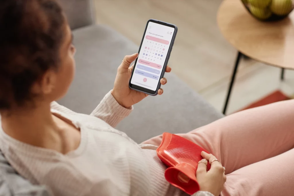 girl-holding-phone-with-period-tracker-app-to-track-her-menstrual-cycle-phases